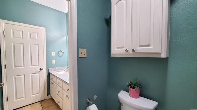 bathroom with vanity, tile patterned floors, and toilet