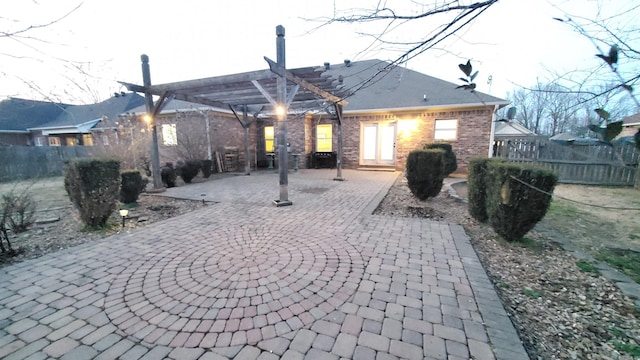 back of property featuring a pergola and a patio area