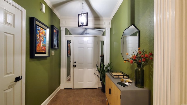 doorway with crown molding and dark tile patterned flooring