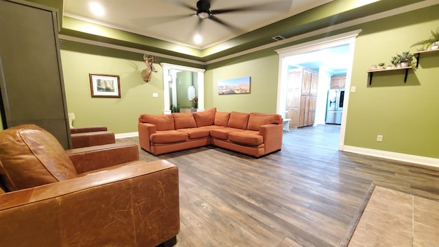 living room with hardwood / wood-style flooring and crown molding