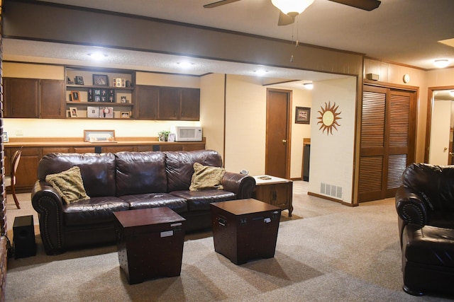 living room featuring light colored carpet and ceiling fan