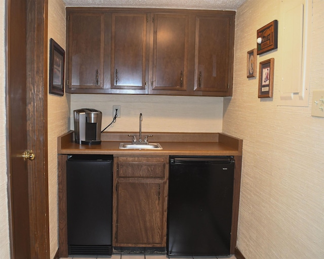 kitchen featuring sink, dark brown cabinets, fridge, and dishwasher