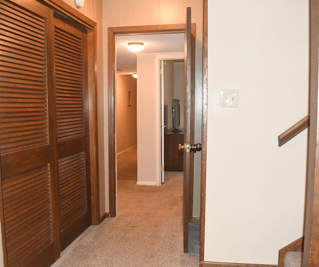 corridor featuring light colored carpet