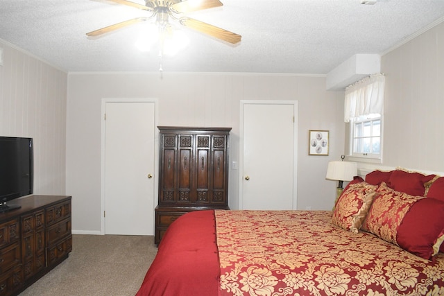 carpeted bedroom featuring ornamental molding, a textured ceiling, and ceiling fan