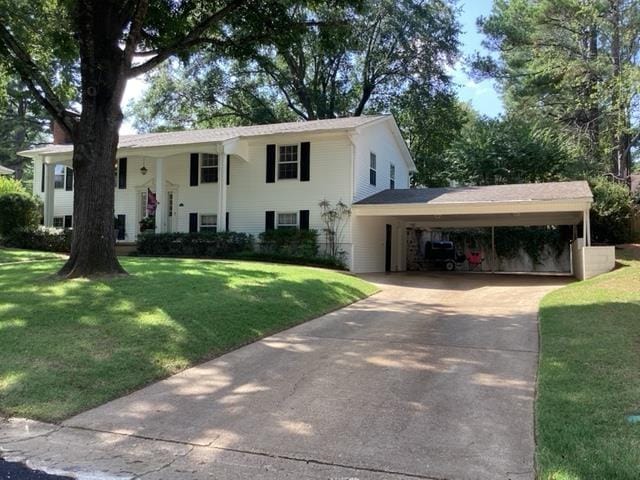 view of front facade with a carport and a front yard