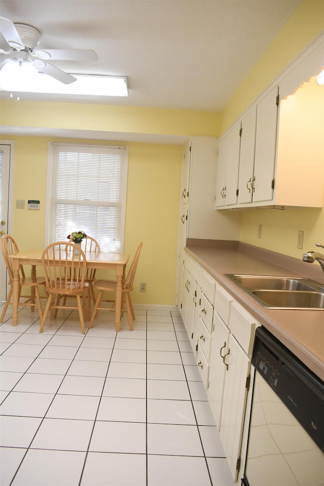 kitchen featuring white cabinetry, white dishwasher, sink, and light tile patterned floors