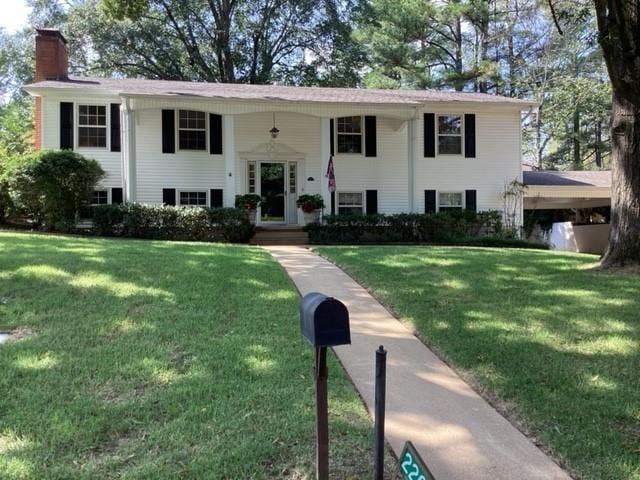 raised ranch with a front yard