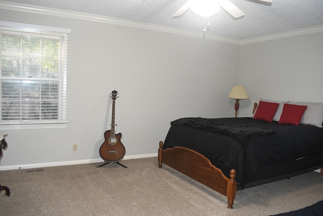 bedroom with ceiling fan, ornamental molding, carpet floors, and a textured ceiling