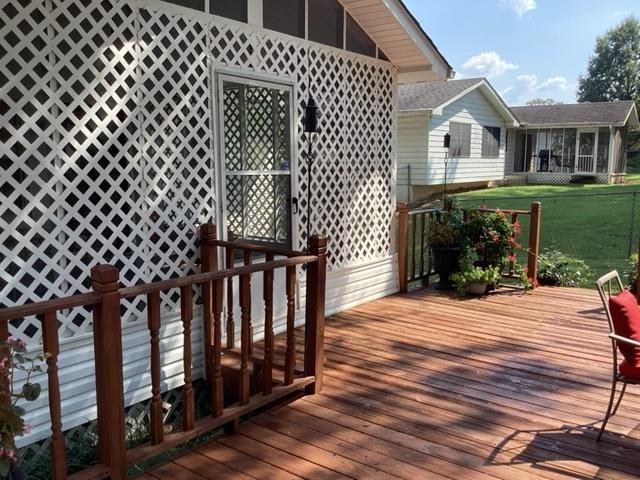 wooden terrace featuring a yard