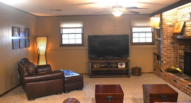 living room featuring a brick fireplace, light carpet, and ceiling fan