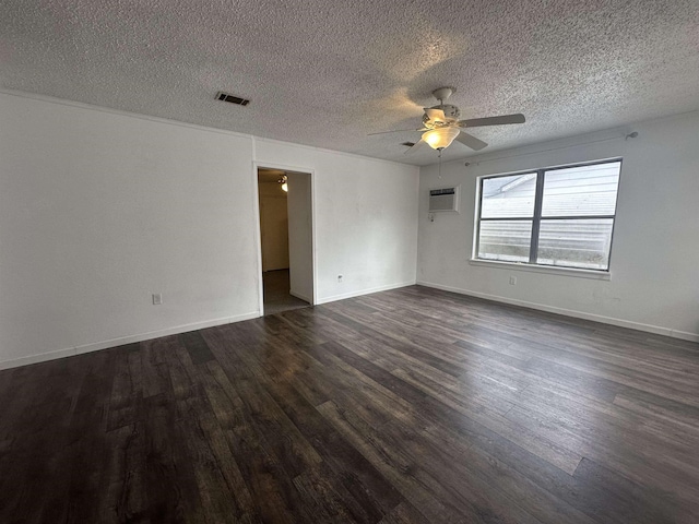 spare room with a textured ceiling, dark hardwood / wood-style floors, and ceiling fan