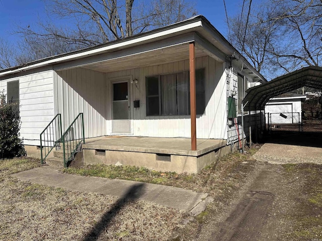 view of front facade with a porch and a carport