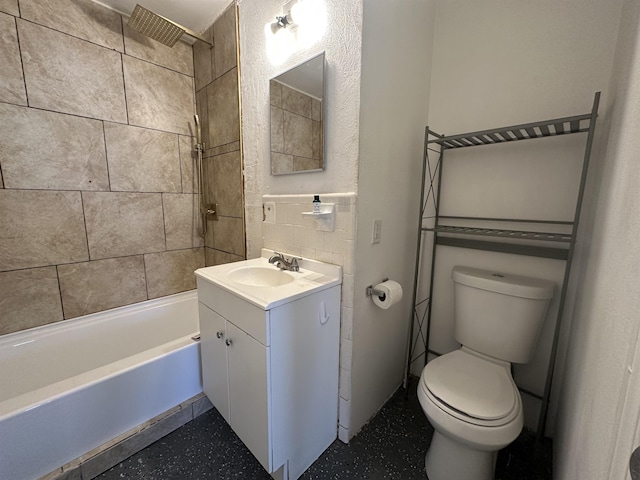 full bathroom featuring vanity, toilet, and tiled shower / bath