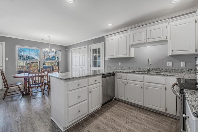 kitchen with sink, appliances with stainless steel finishes, white cabinetry, hanging light fixtures, and kitchen peninsula