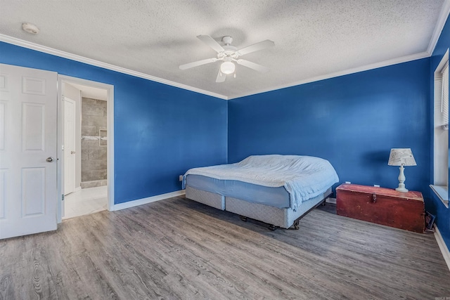 bedroom featuring ensuite bath, wood-type flooring, ceiling fan, crown molding, and a textured ceiling