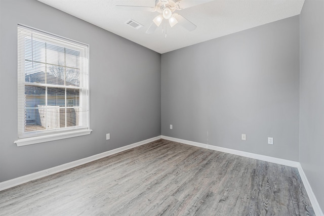 spare room with ceiling fan and light hardwood / wood-style floors