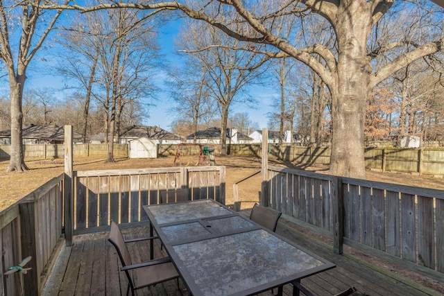 wooden deck featuring a storage unit