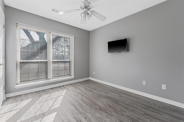 empty room featuring hardwood / wood-style flooring and ceiling fan