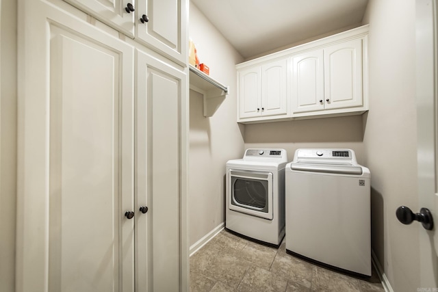 washroom featuring cabinets and separate washer and dryer