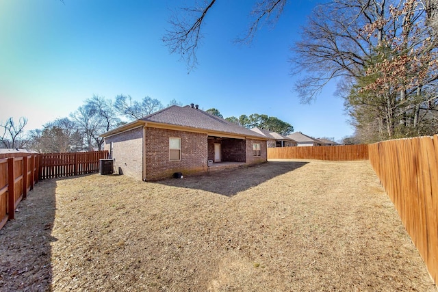 rear view of house with central AC unit