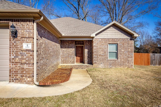 doorway to property with a lawn