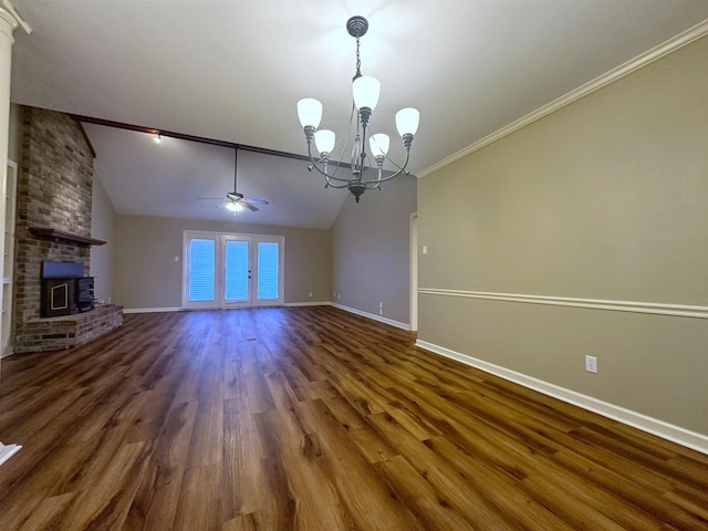 unfurnished living room featuring vaulted ceiling, a brick fireplace, ornamental molding, dark hardwood / wood-style flooring, and ceiling fan with notable chandelier