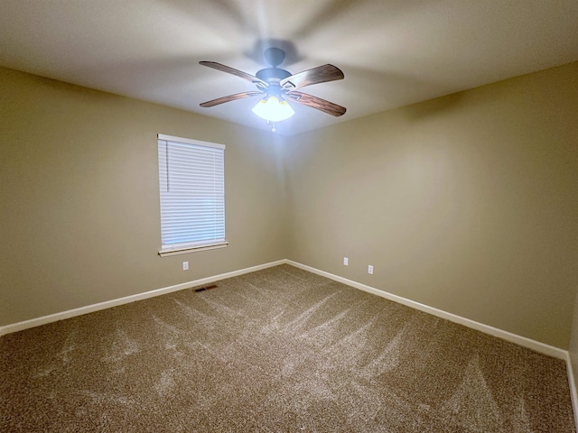 carpeted spare room featuring ceiling fan