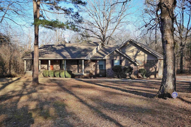 ranch-style house with a front lawn and covered porch