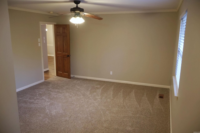 carpeted empty room with crown molding and ceiling fan