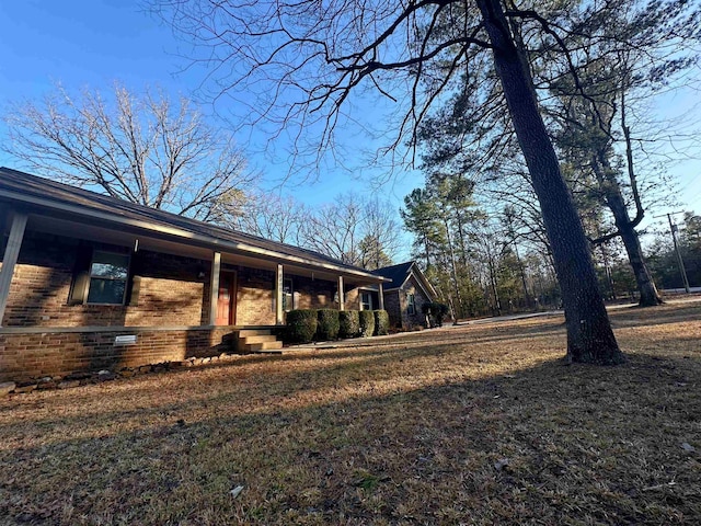 view of side of home with covered porch