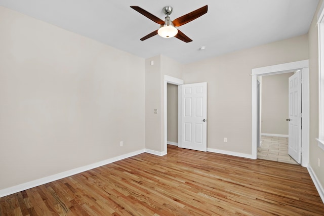 unfurnished bedroom with ceiling fan and light hardwood / wood-style flooring