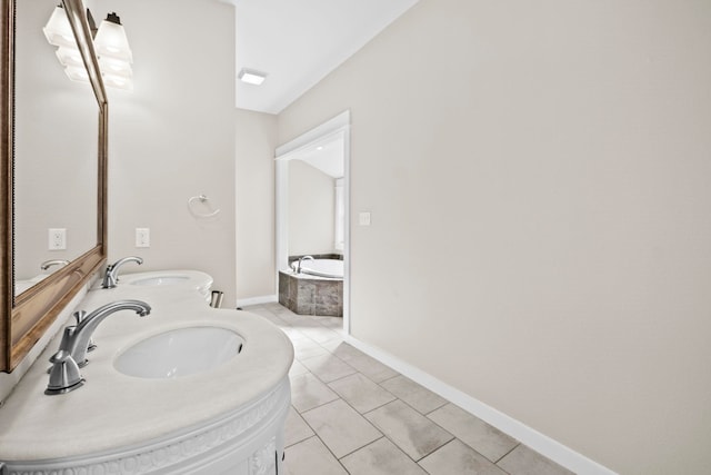 bathroom with tiled tub, vanity, and tile patterned floors