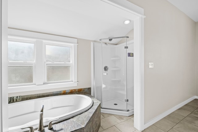 bathroom featuring lofted ceiling, tile patterned floors, and plus walk in shower