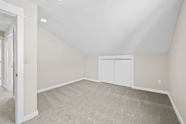 additional living space with lofted ceiling and light colored carpet