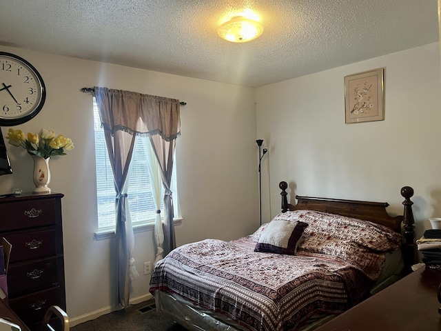 bedroom with carpet and a textured ceiling