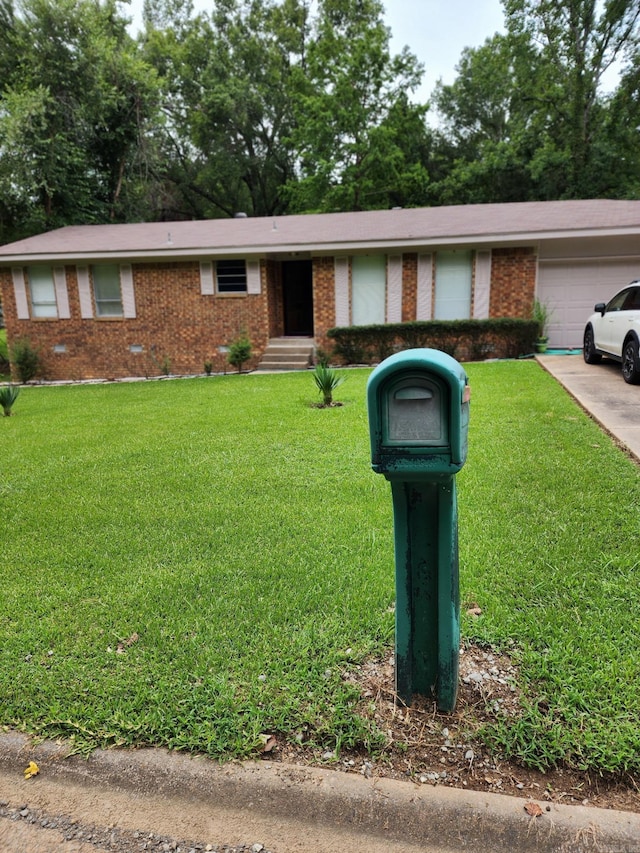 single story home featuring a garage and a front lawn