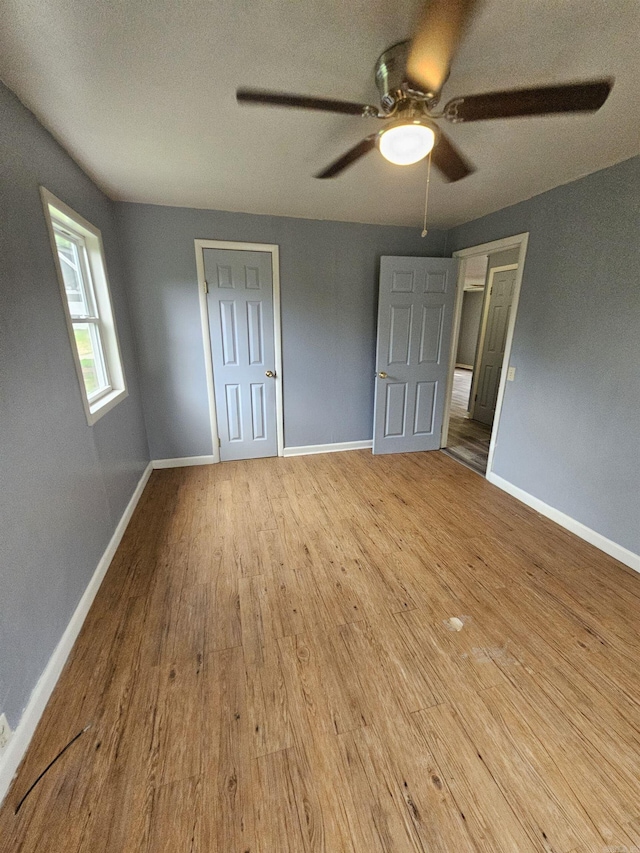 unfurnished bedroom featuring ceiling fan and light hardwood / wood-style floors