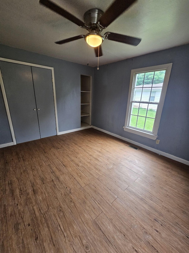 unfurnished bedroom with a closet, ceiling fan, a textured ceiling, and light hardwood / wood-style flooring