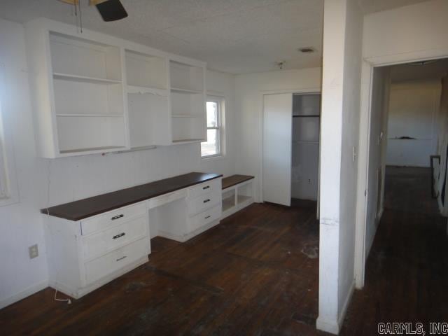 interior space with built in desk and dark hardwood / wood-style floors