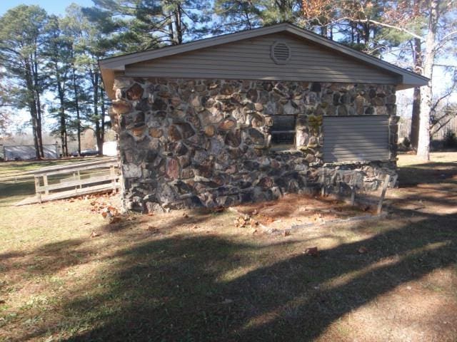 view of side of property with a yard