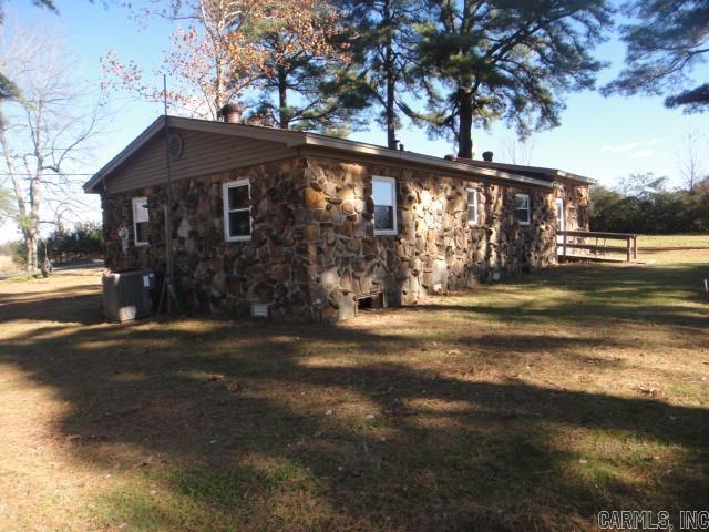 view of side of home with a yard