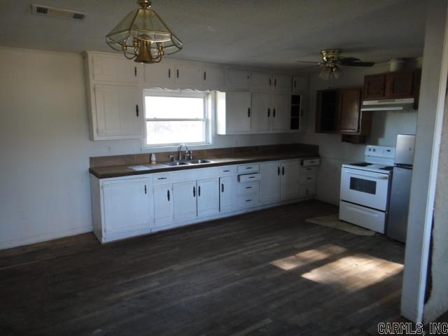 kitchen with dark wood-type flooring, sink, white cabinetry, electric range, and ceiling fan