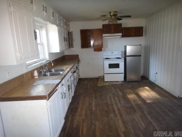 kitchen featuring white electric range, sink, stainless steel refrigerator, dark hardwood / wood-style floors, and ceiling fan