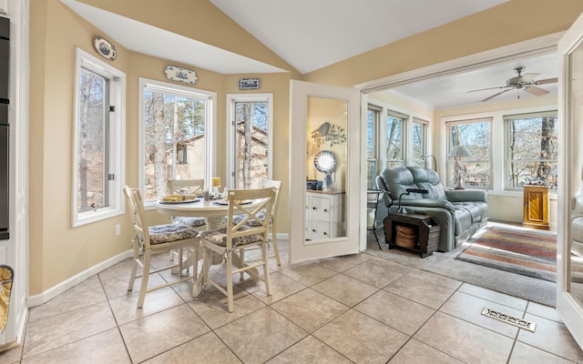 sunroom with ceiling fan and vaulted ceiling