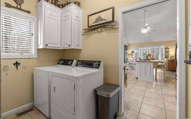 laundry room featuring a wealth of natural light, washing machine and clothes dryer, and light tile patterned flooring