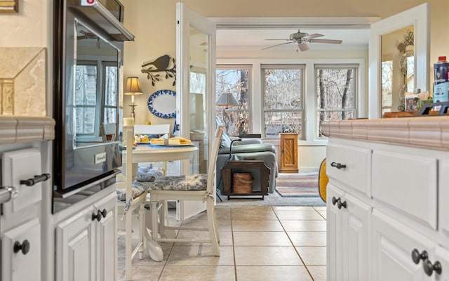 kitchen featuring white cabinetry, ceiling fan, and light tile patterned flooring