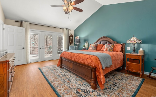 bedroom with lofted ceiling, access to exterior, ceiling fan, light hardwood / wood-style floors, and french doors