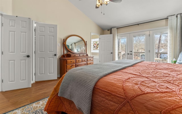 bedroom with french doors, high vaulted ceiling, access to outside, ceiling fan, and light hardwood / wood-style floors