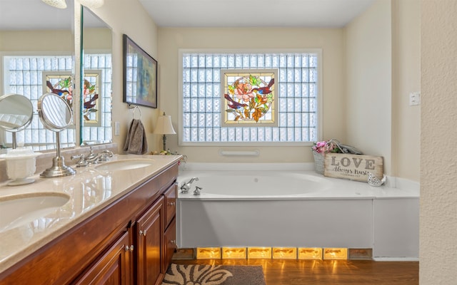 bathroom with vanity and a tub to relax in