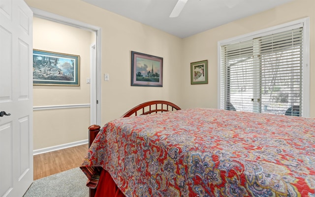 bedroom with wood-type flooring and ceiling fan